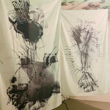 White curtains with black drawings on them